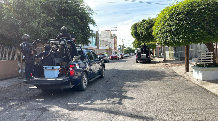 Dos unidades policiacas en vialidad con elementos arriba de ellas