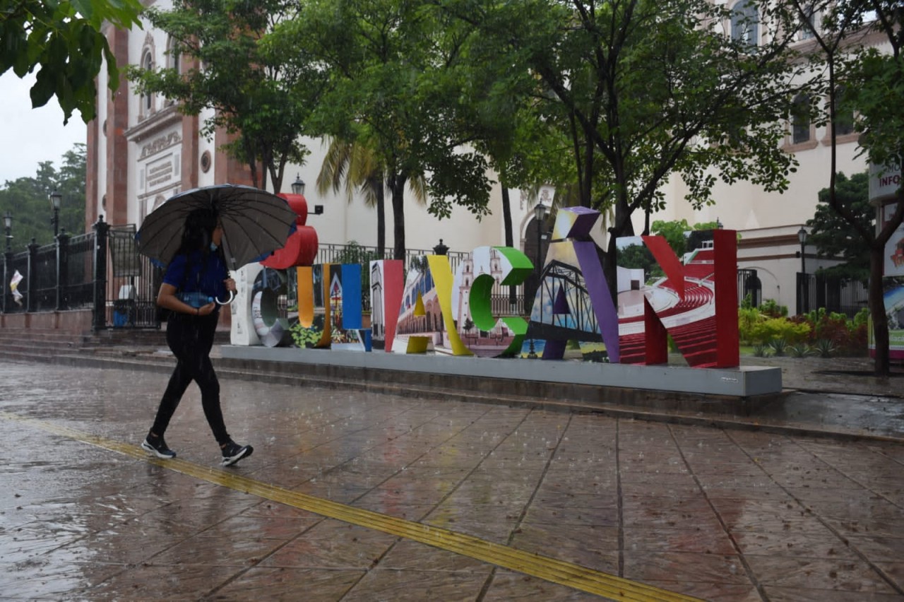 Persona caminando con un paraguas cubriendose de la lluvia