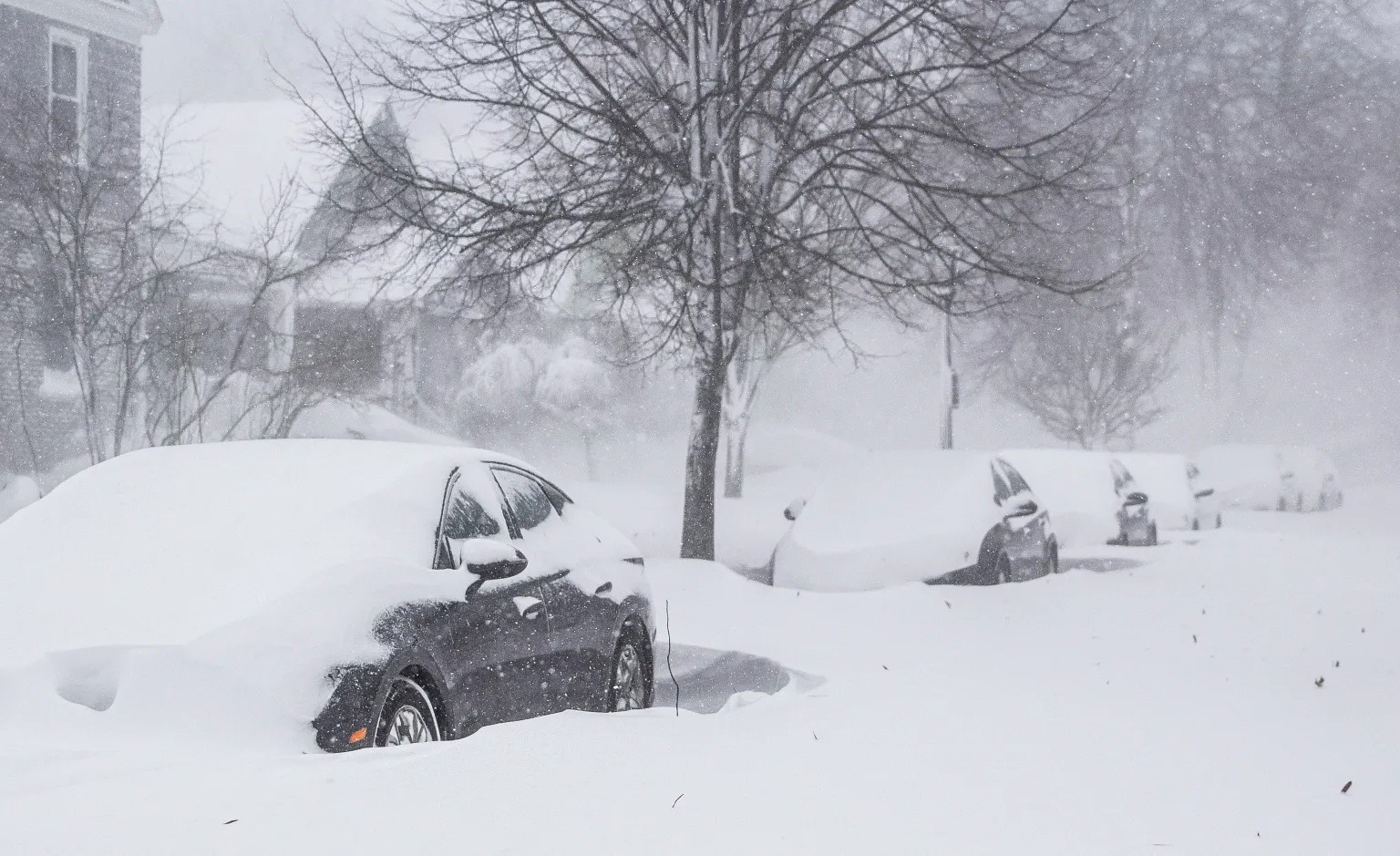 carros en la calle cubiertos por la nieve