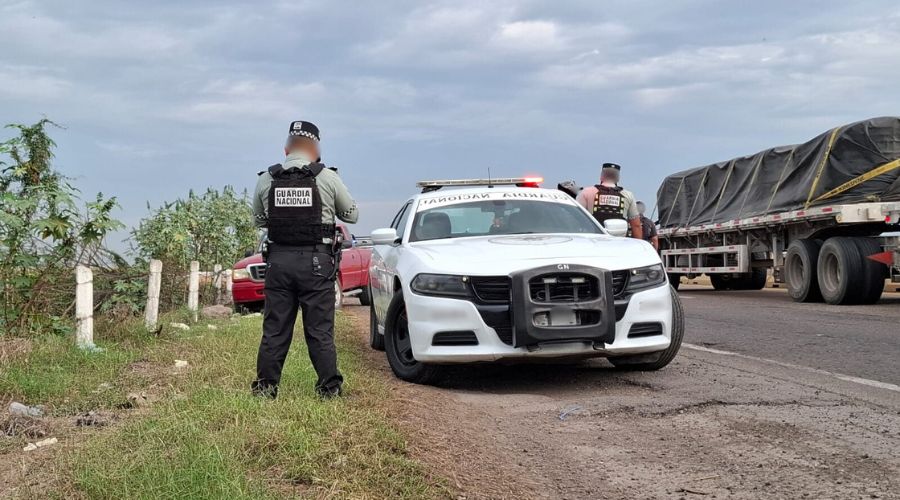 Personal y unidad de la Guardia Nacional en una carretera, al fondo se observa una camioneta roja
