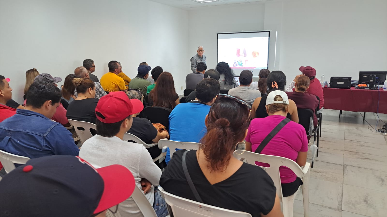 Comerciantes sentados recibiendo capacitación