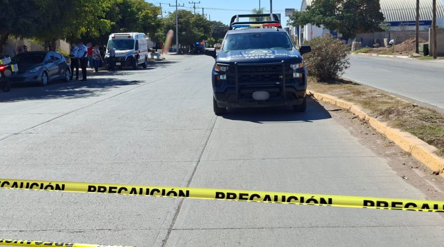 Cinta amarilla de precaución en una calle cerca de unidades de emergencia, patrulla y ambulancia
