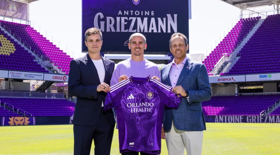 Antoine Griezmann posando para foto con camiseta de futbol en las manos