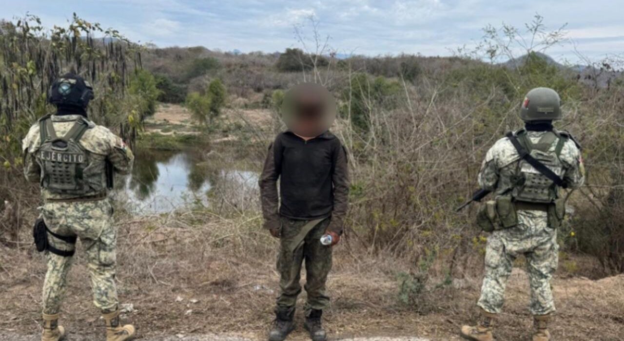 Dos elementos del Ejército Mexicano junto a persona detenida