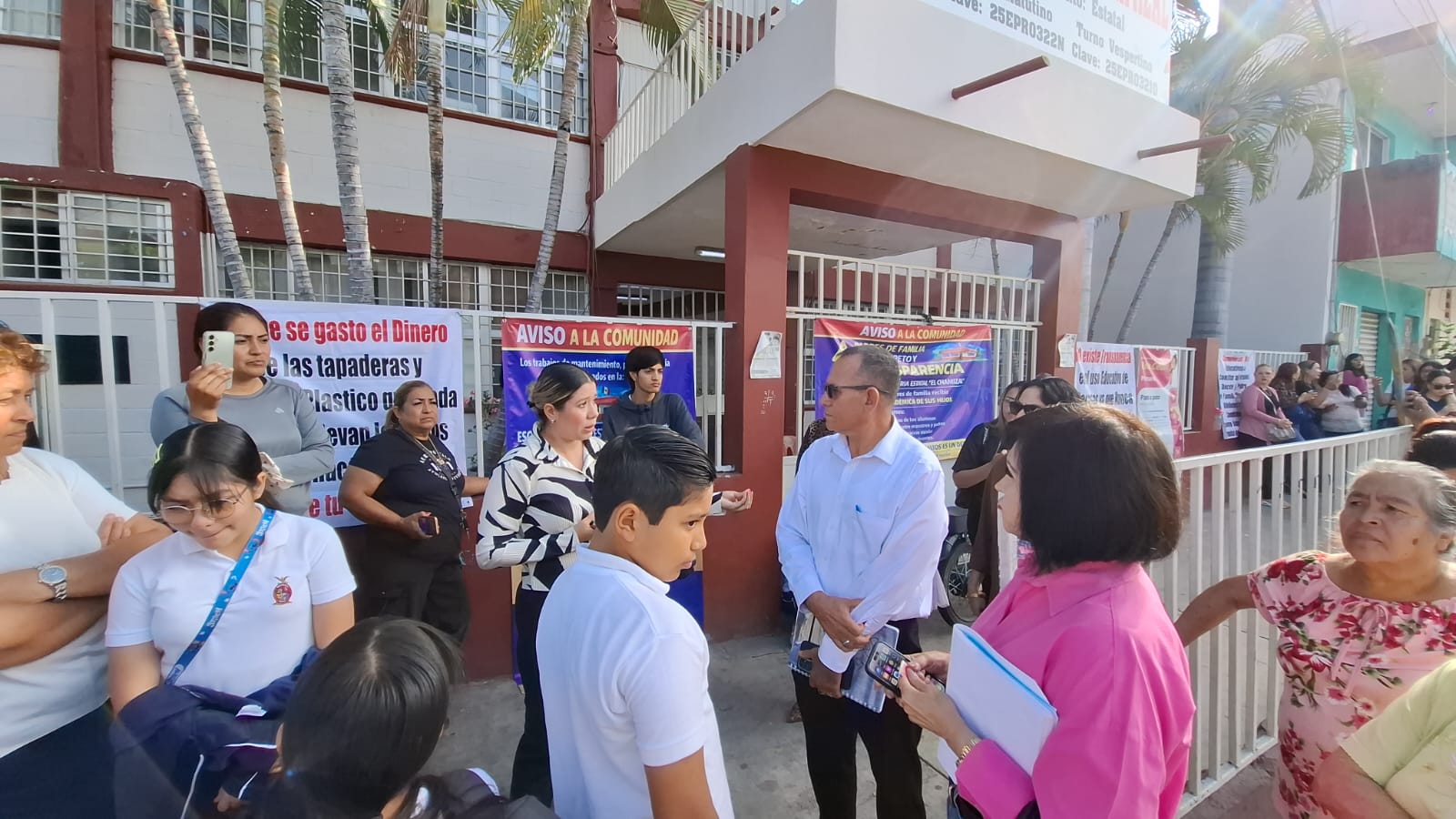 Padres de familia y autoridades a las afueras de una instalación educativa