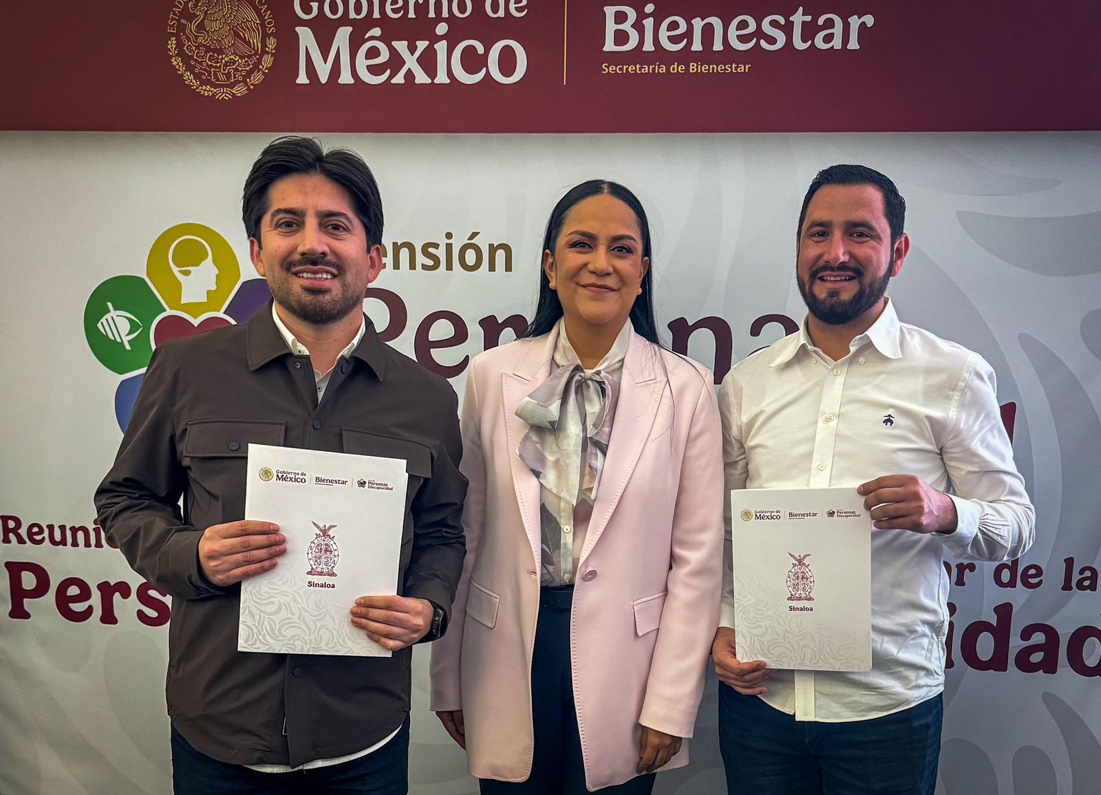 Personas sosteniendo hojas adelante de una mampara