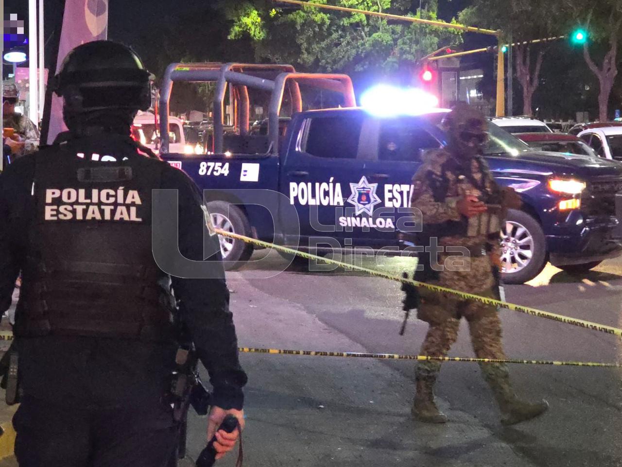 elementos de la Policía Estatal y Militar en una calle junto a una patrulla