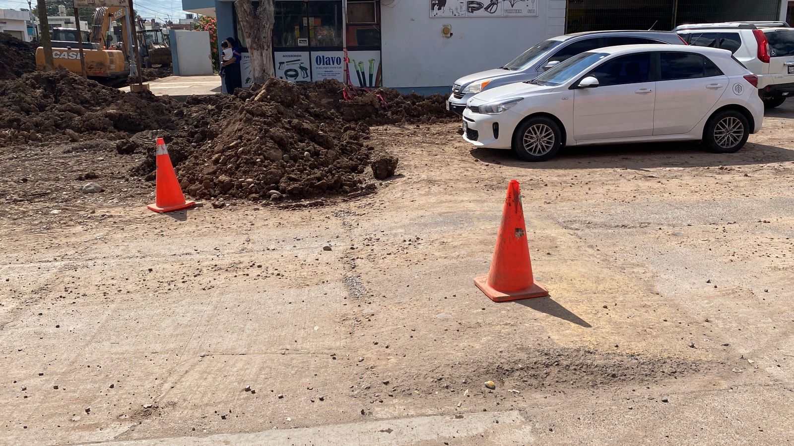 Calle con conos y montañas de tierra