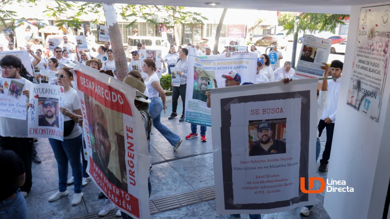 Personas sosteniendo pancartas y carteles de búsqueda