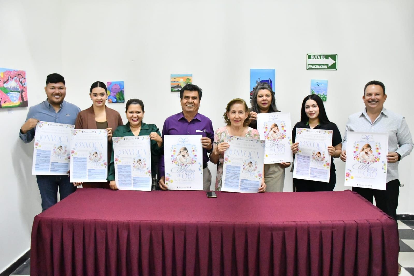 Grupo de autoridades y organizadores posa sosteniendo carteles de la convocatoria “Mamá de Oro 2026” durante la presentación oficial en Mocorito.