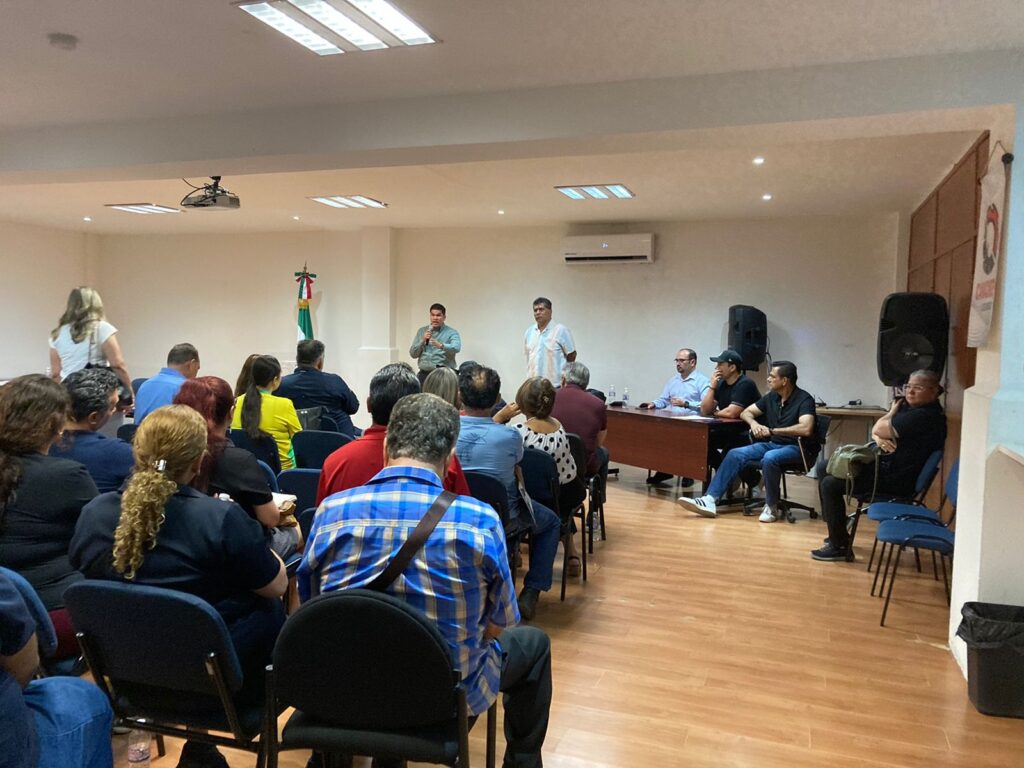 Personas afectadas de incendio sentadas frente a directivos de la FGE