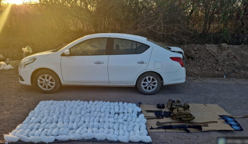 Vehículo blanco junto a droga, armas