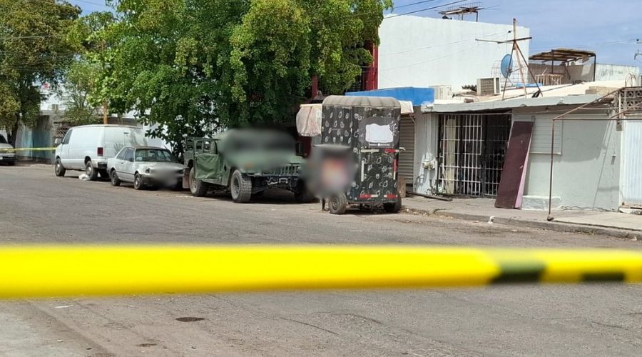 Cinta amarilla de precaución con una camioneta del Ejército Mexicano