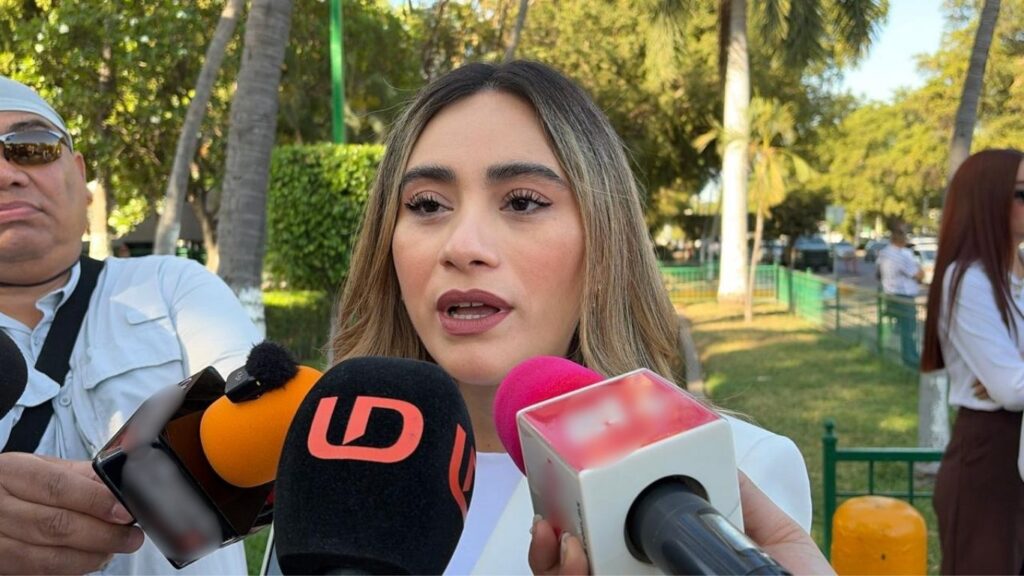 Brenda García hablando a micrófonos de noticieros