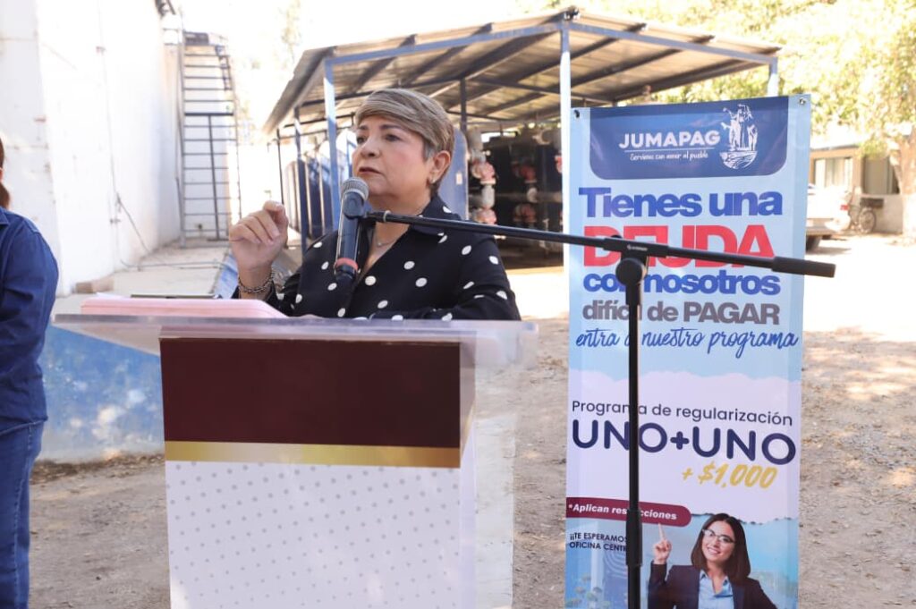 Alcaldesa de Guasave con un micrófono y un atril