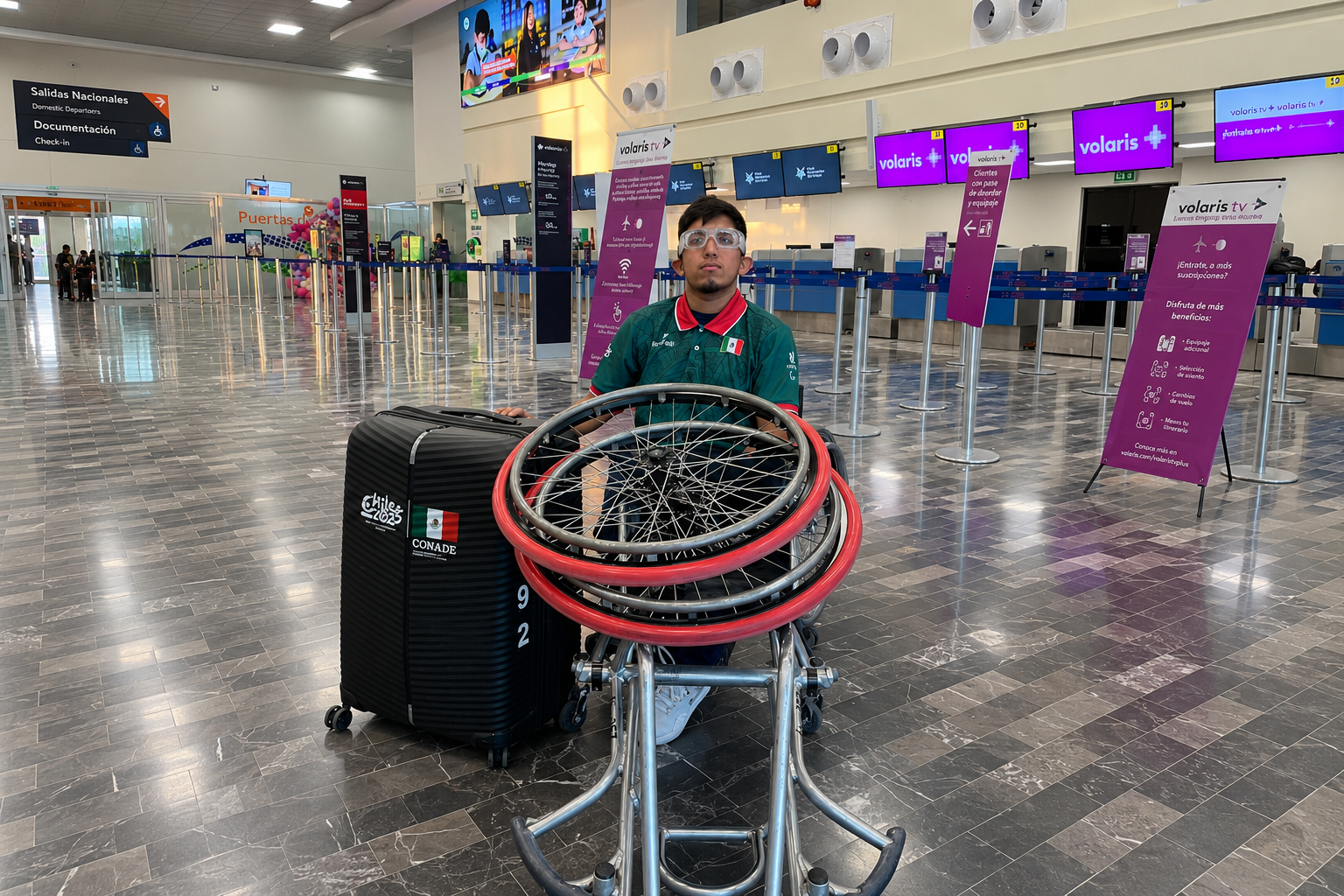 Máximo Zavala, joven atleta de Ahome, posa en silla de ruedas dentro del Aeropuerto Internacional de Los Mochis junto a su equipaje y ruedas deportivas, mientras busca un lugar en la selección mexicana de basquetbol en silla de ruedas.