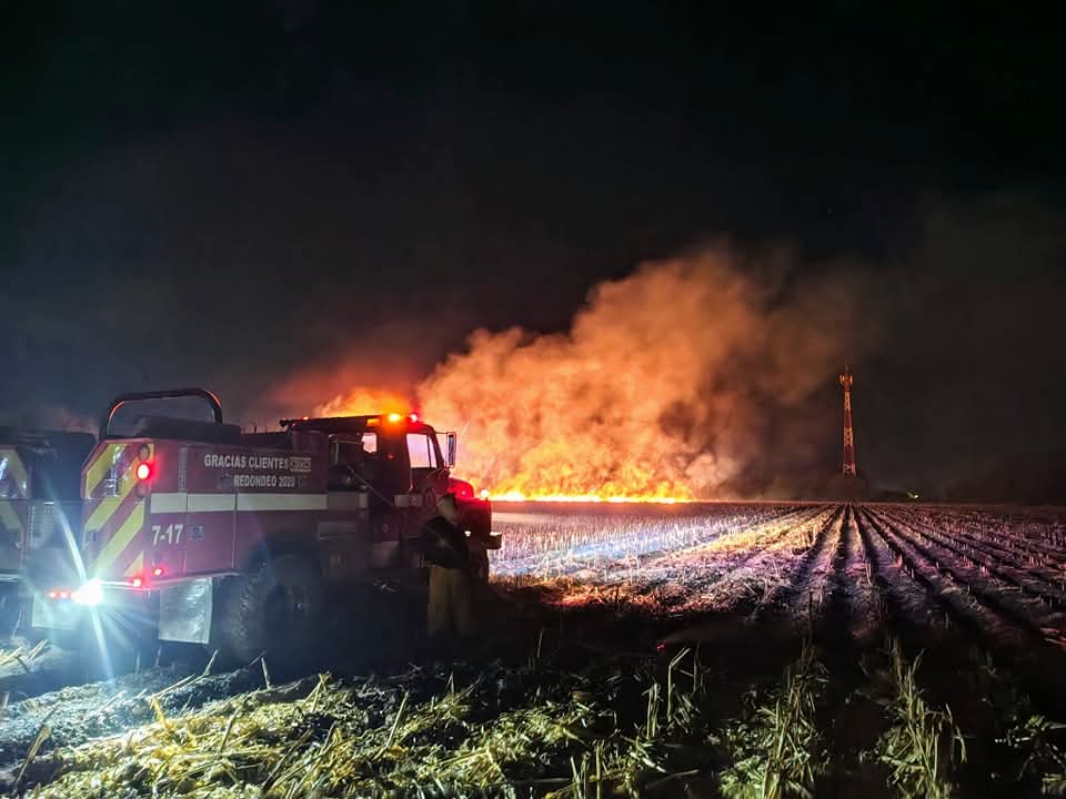 Camión de bomebros con lumbre o fuego al fondo