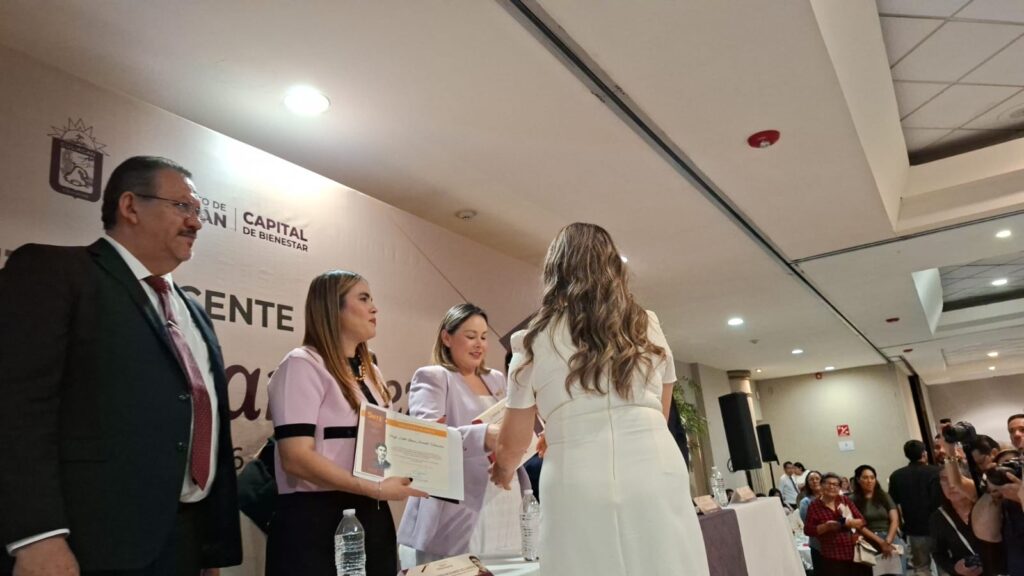 Directivos entregando reconocimientos a maestros