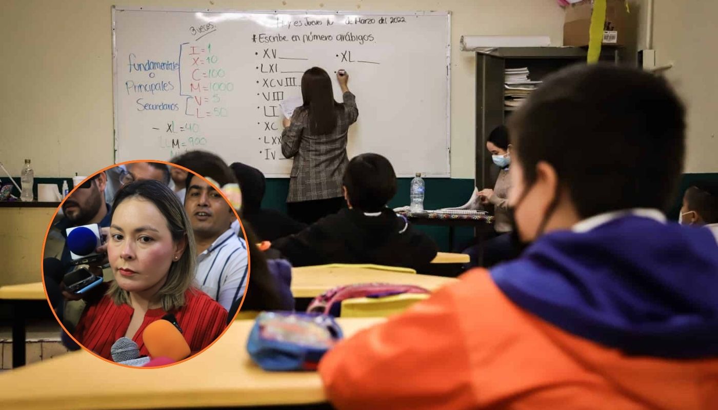 En grande salón de clases con alumnos y maestra escribiendo en el pizarrón y en circulo gobernadora de Sinaloa