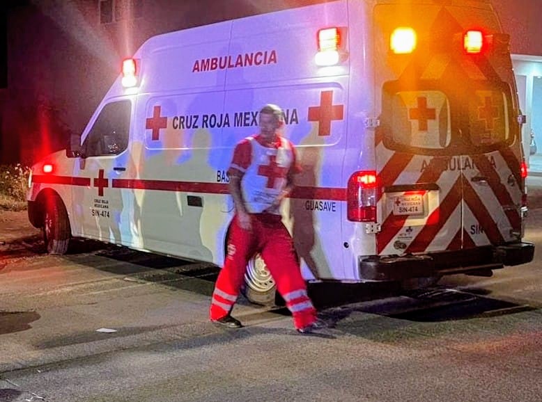 Ambulancia con luces encendidas y paramédico a un lado