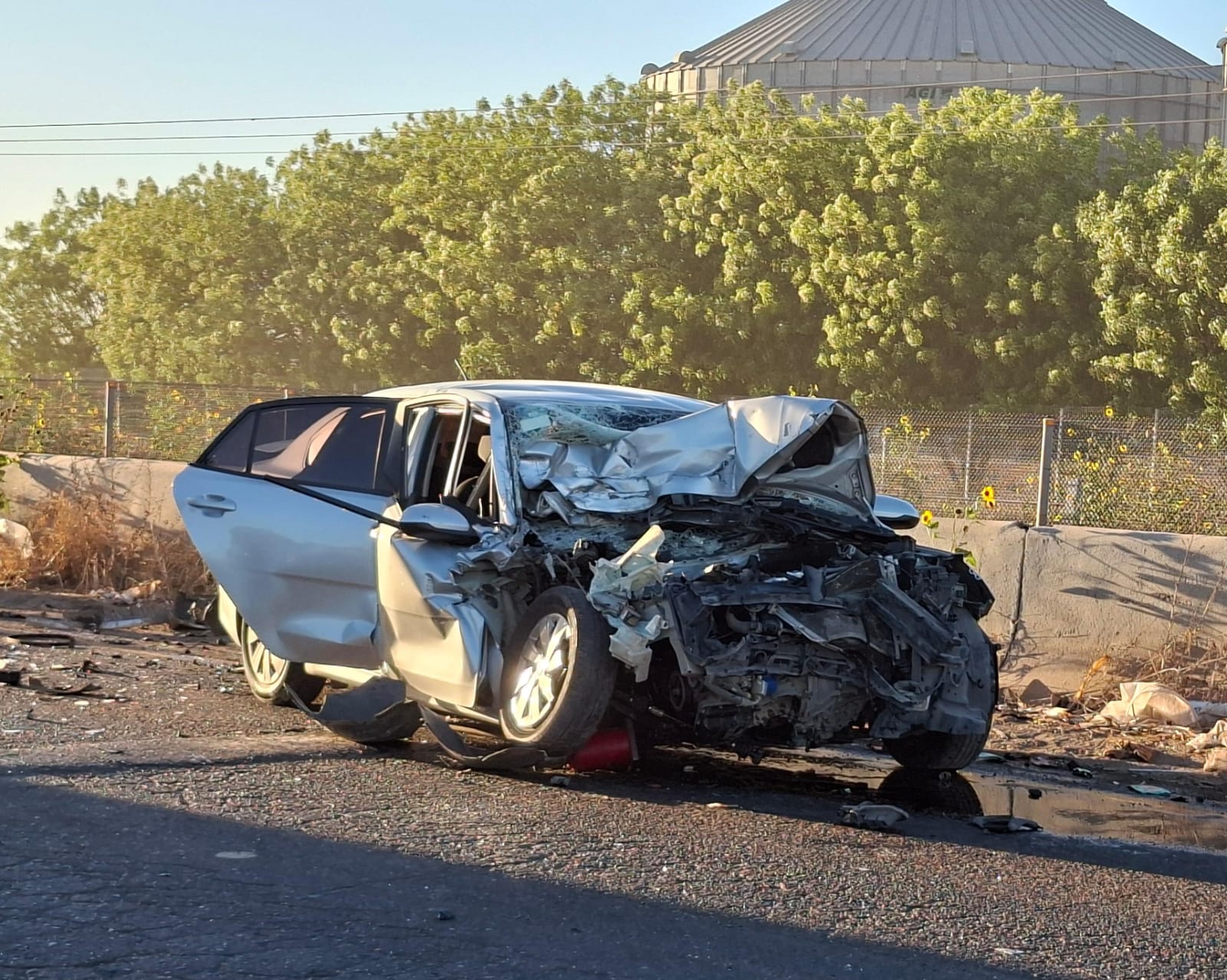 Carro con el frente destrozado junto a el cristal quebrado
