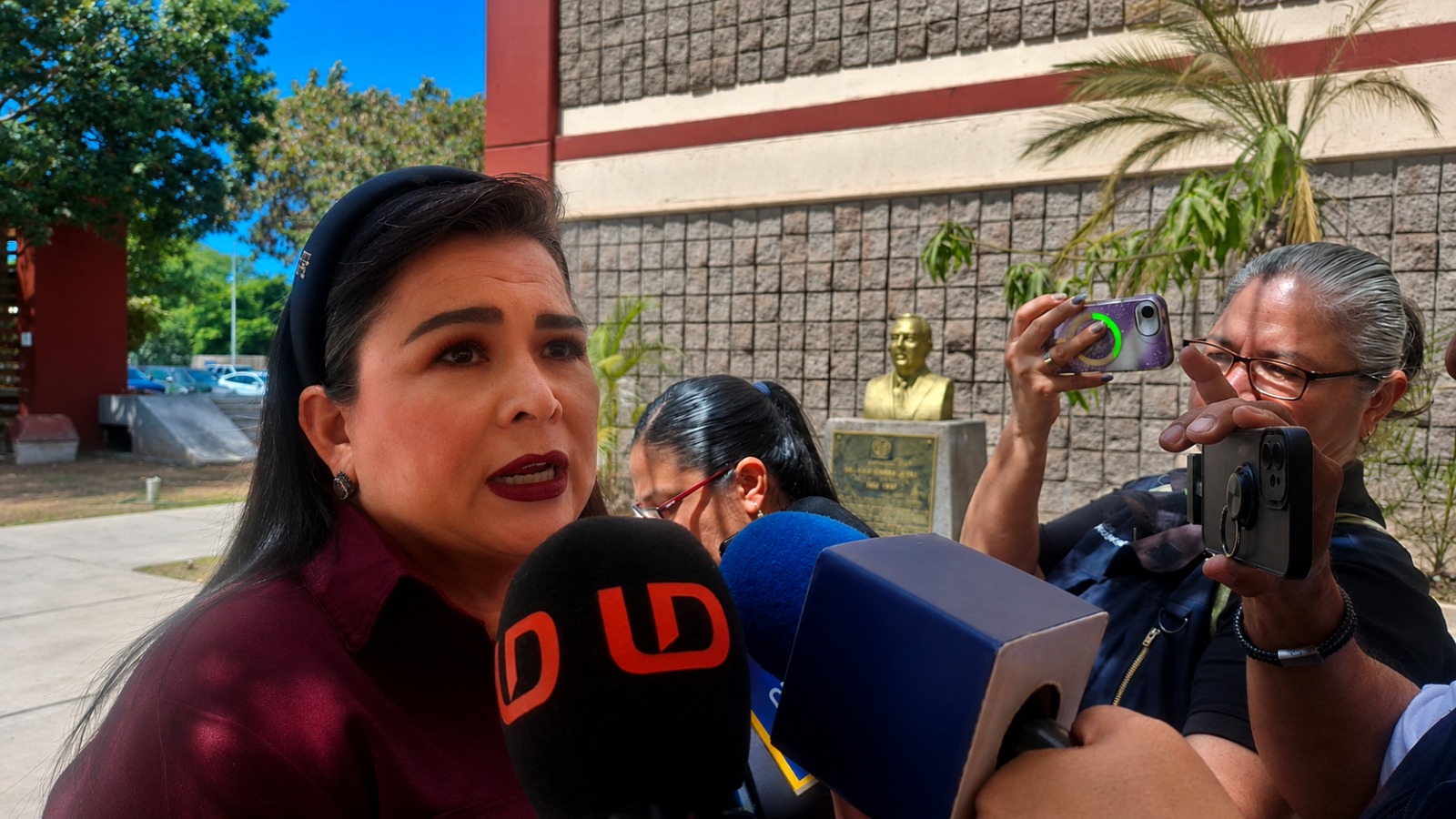 Ana Ayala con micrófonos de la prensa
