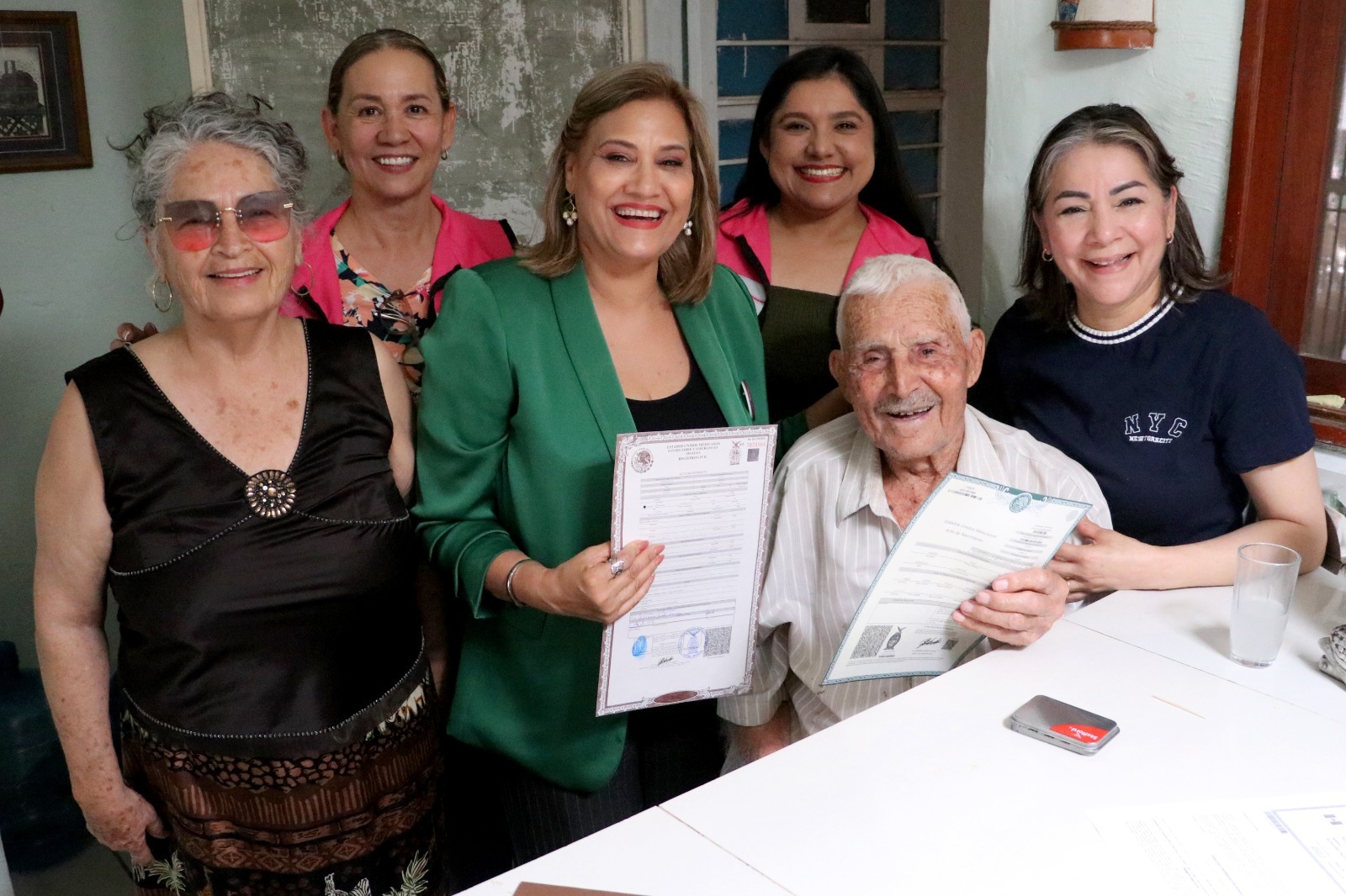 Don Rosario, de 103 años, recibiendo su acta de nacimiento junto a sus seres queridos y con ayuda del DIF Ahome.