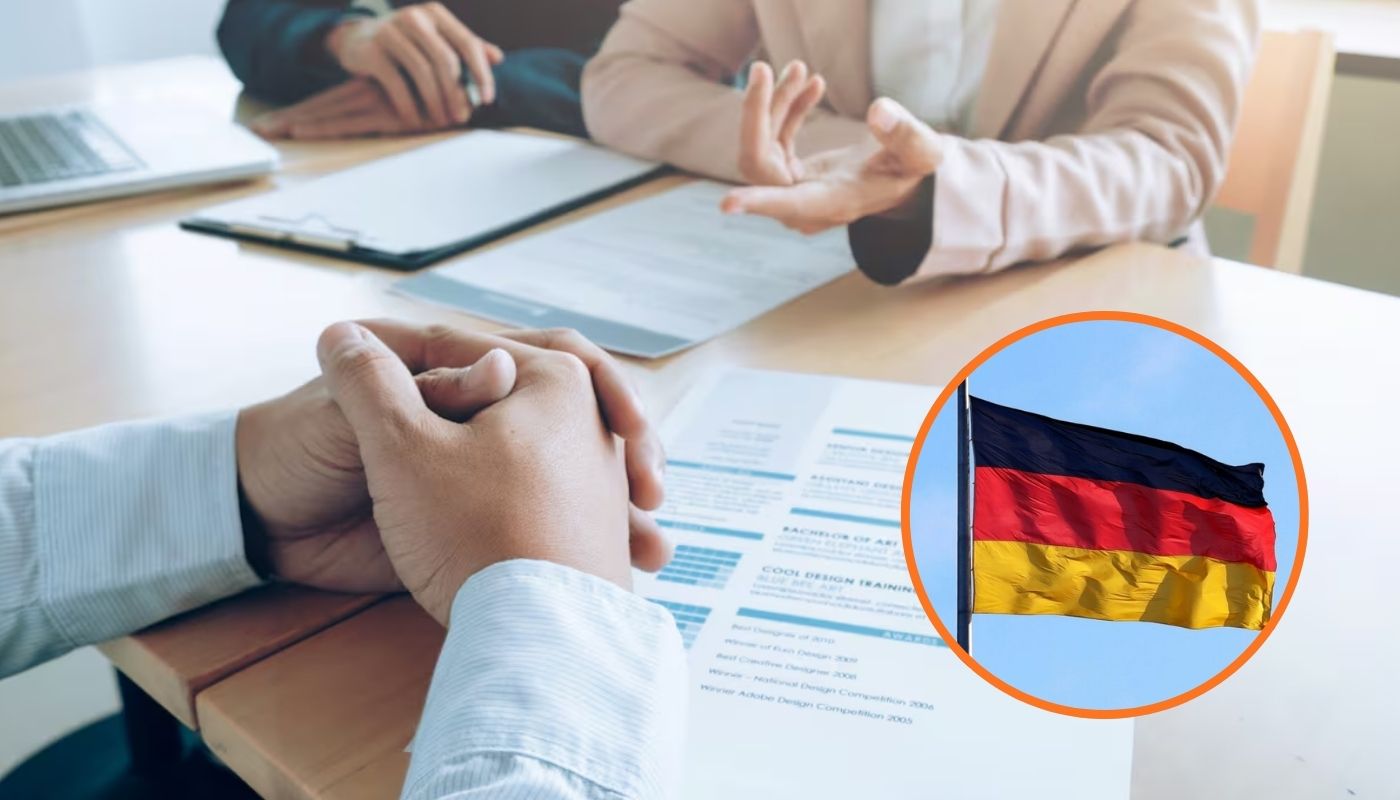 Dos personas con las manos en la mesa y un circulo con la bandera de Alemania