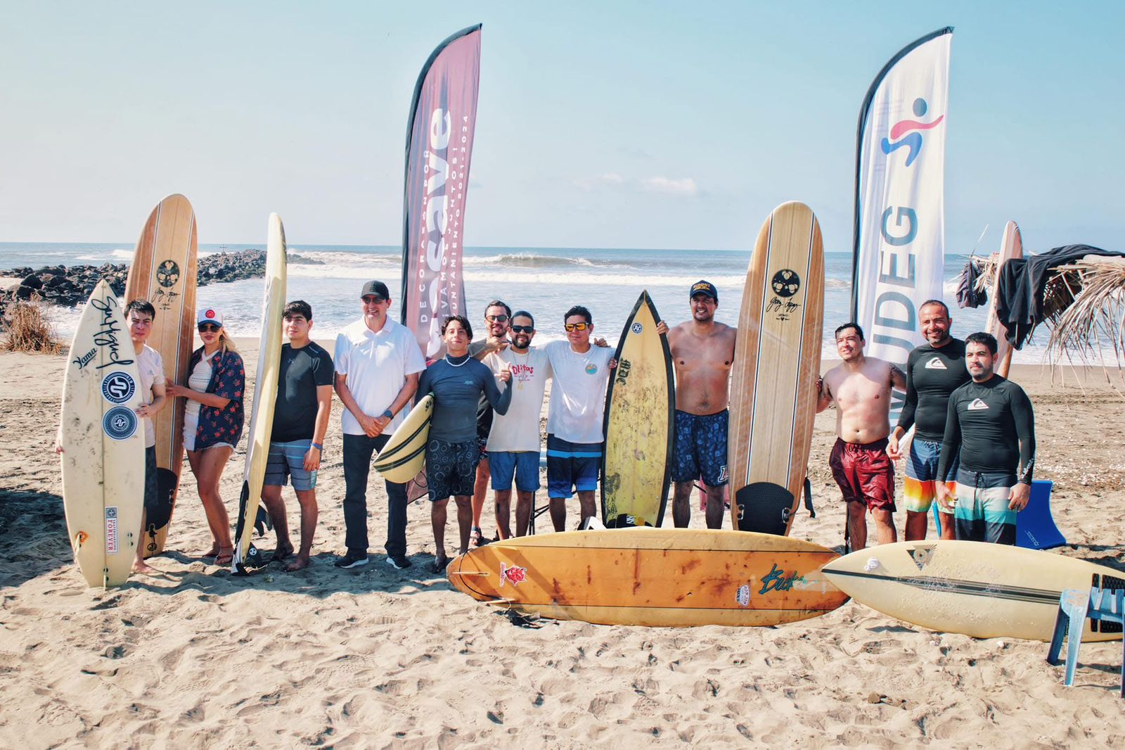 Personas con tablas de surf en una playa a la orilla del mar