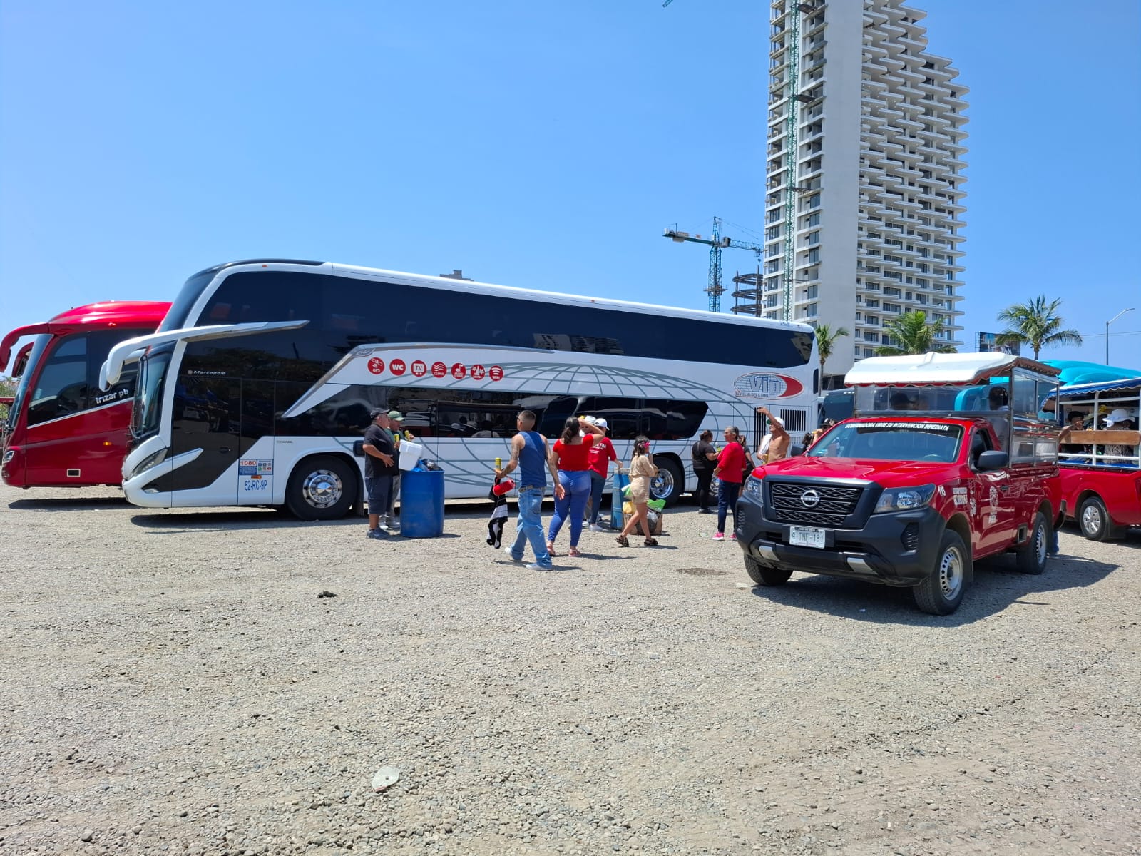 Autobuses y camiones charteros y personas descargando equipaje