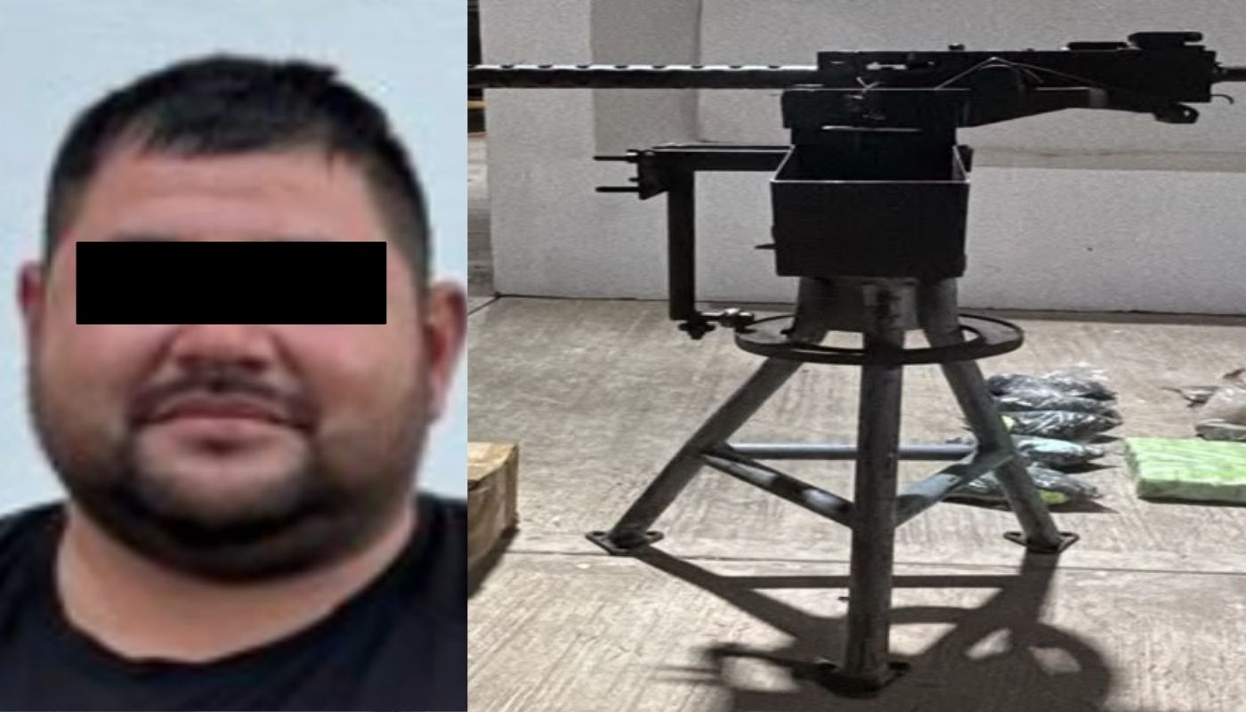Un hombre con barba y una cintilla negra en los ojos junto a una ametralladora