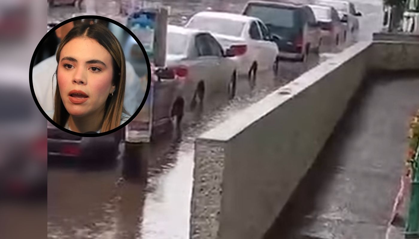 Calle inundada junto a un ciruclo con la alcaldesa de Culiacán