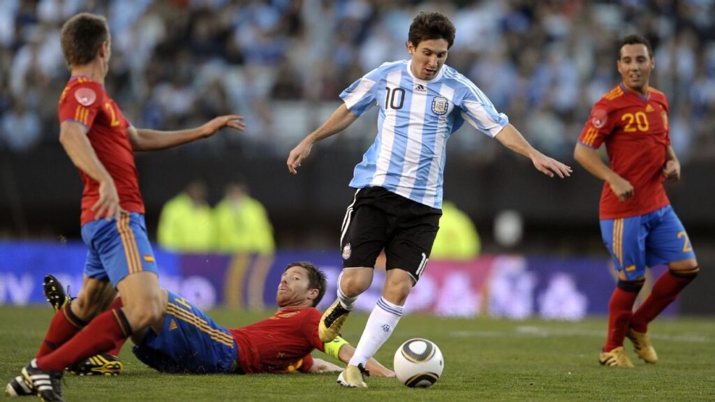 jugadores de futbol de las selecciones de Argentina y España, en un estadio de futbol durante un partido
