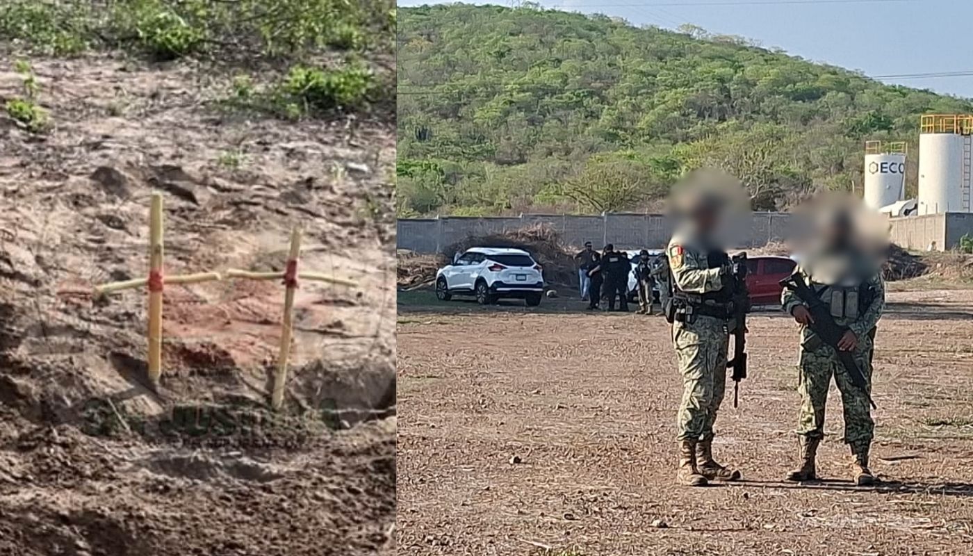 Dos elementos del ejército junto a dos cruces de madera enterradas